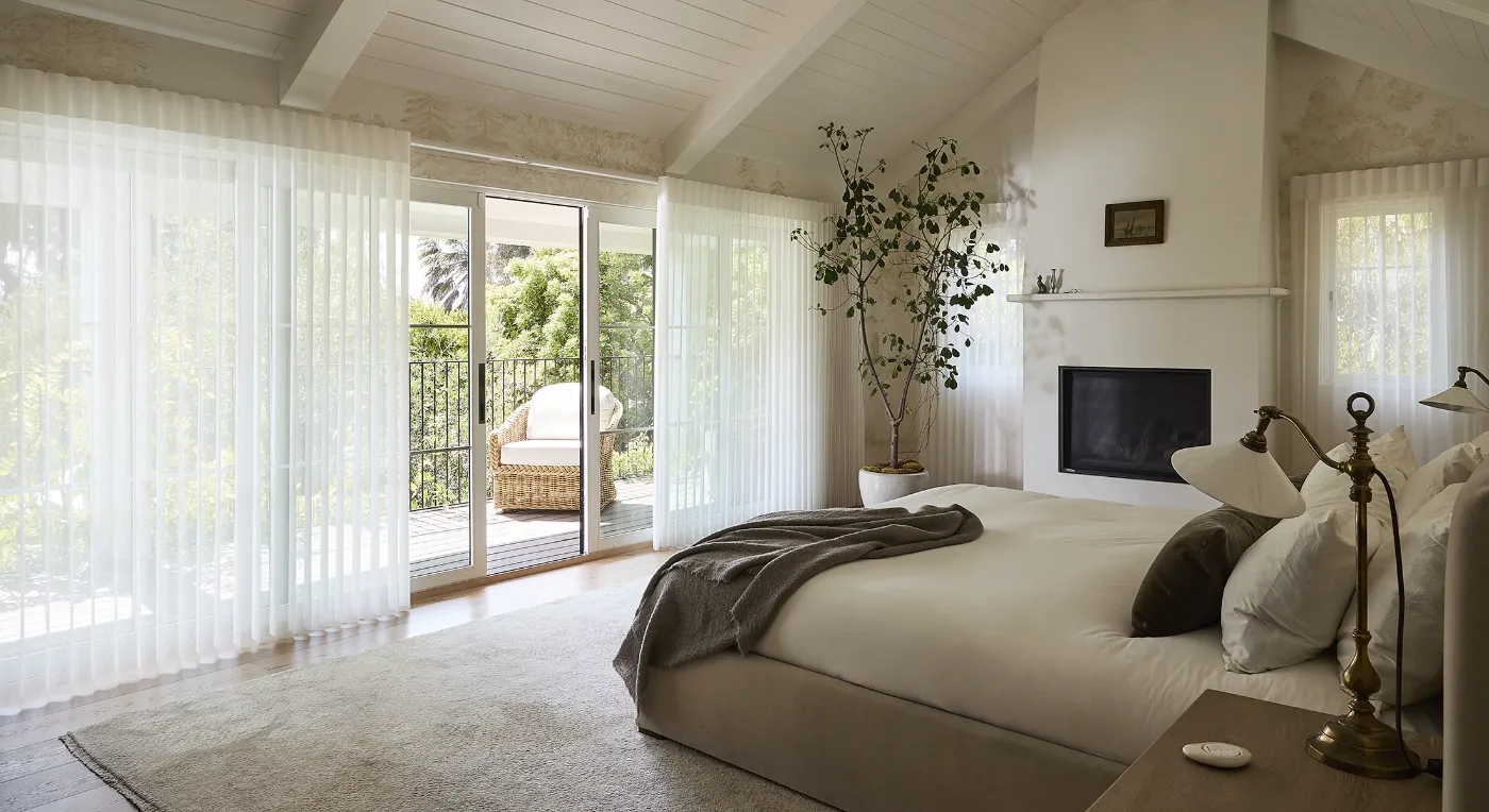 Hunter Douglas Luminette Privacy Sheers on a bedroom patio door, available at Northwest Decor & Furniture in Sheldon, IA